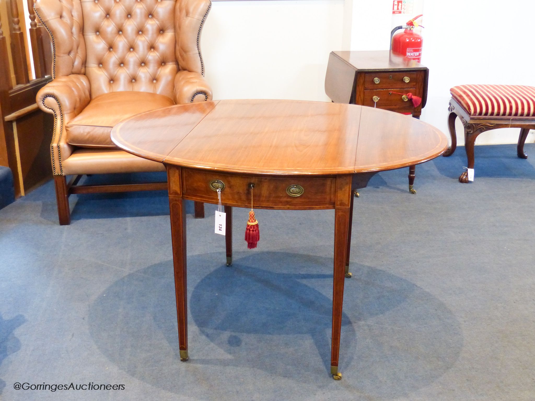 A George III Sheraton period mahogany and satinwood banded oval Pembroke table, 111.5 cm long when open, 83.5 cm deep, 72 cm high